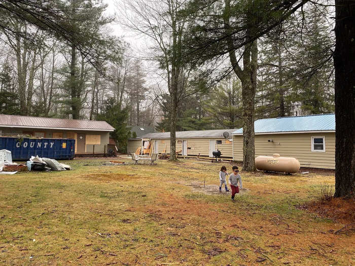 The outdoor area of a motel with children running on the grass