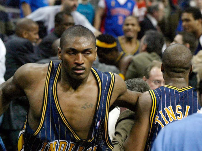 Ron Artest charges the stands.