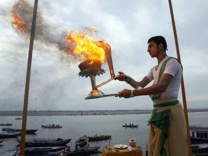 Oil lamps burn across the city, and the sounds of temple life, of prayer and bells, reverberate from the temples.