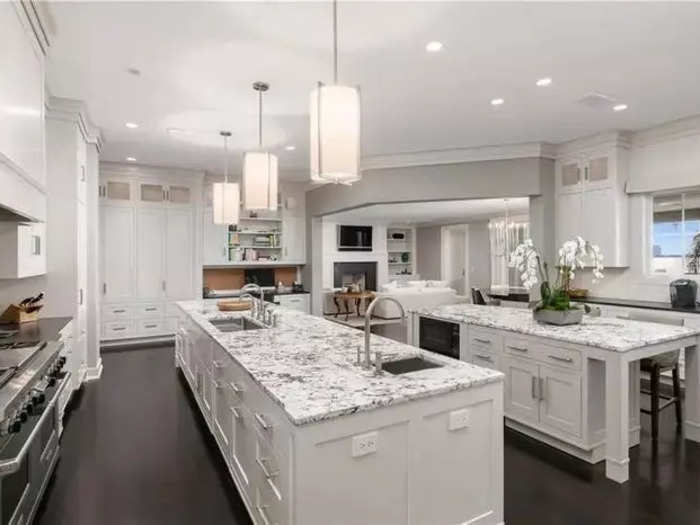 The bright and airy kitchen features two islands and gorgeous finishes.