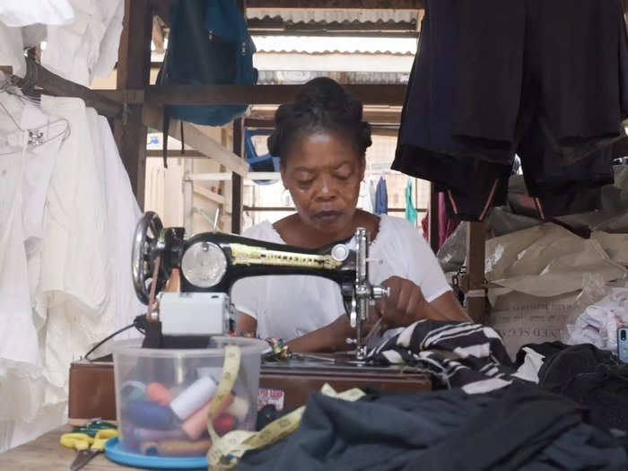 In order to improve quality, Kantamanto workers dye denim jeans to make them look new, buff shoes to improve their color, and recruit onsite tailors to sew damaged clothing.