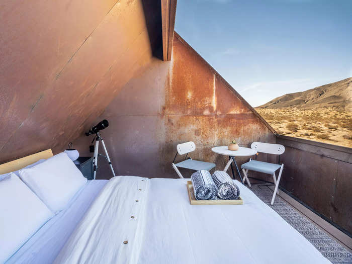 The deck is equipped with a bed, telescope, and seating area.