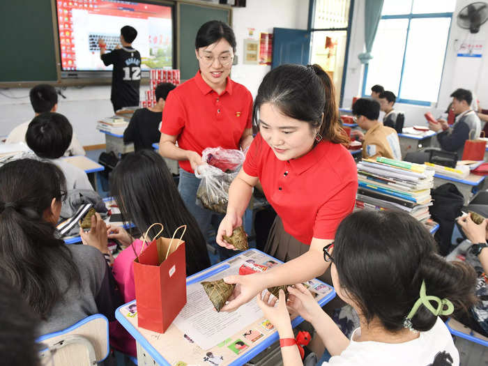 Schools often try to help their students cope with fun activities or gifts, like these lucky dumplings being handed out by teachers in Changsha.