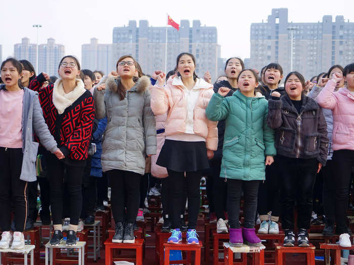 These students in Henan are taking an oath to do their best for the Gao Kao during a pep rally in 2018.