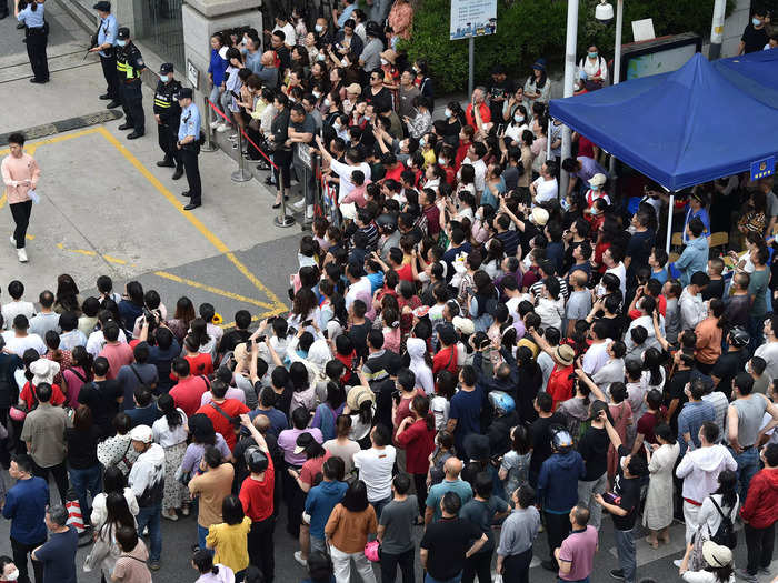 Anxious parents often swarm test venues, like this crowd waiting for their kids to finish the Gao Kao in Nanjing.