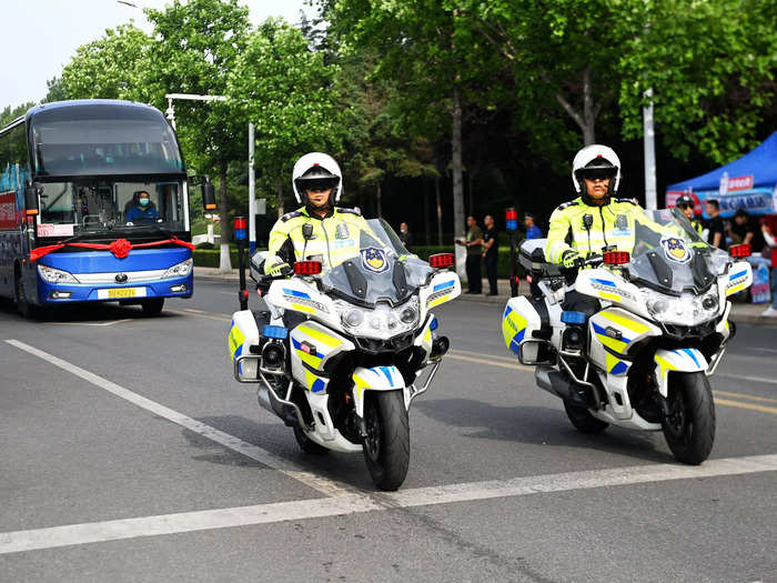 On the day of the exam, some authorities arrange for traffic police — like the ones here in Qingdao — to escort students who come by the busload.