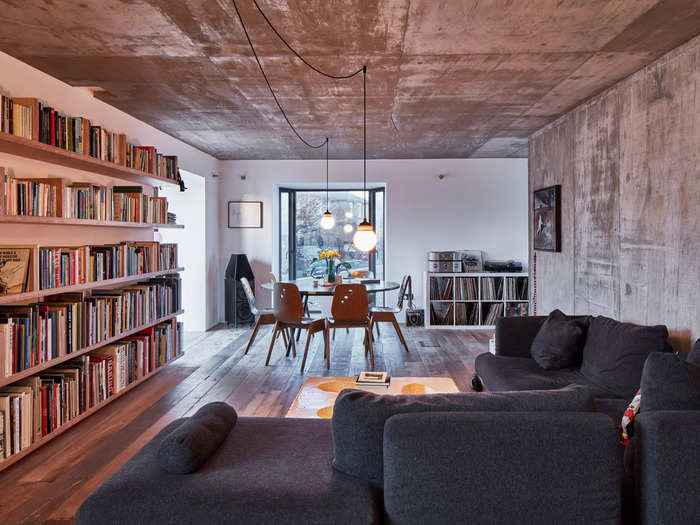 The interior of Mole House uses exposed concrete and timber, creating a rustic atmosphere.