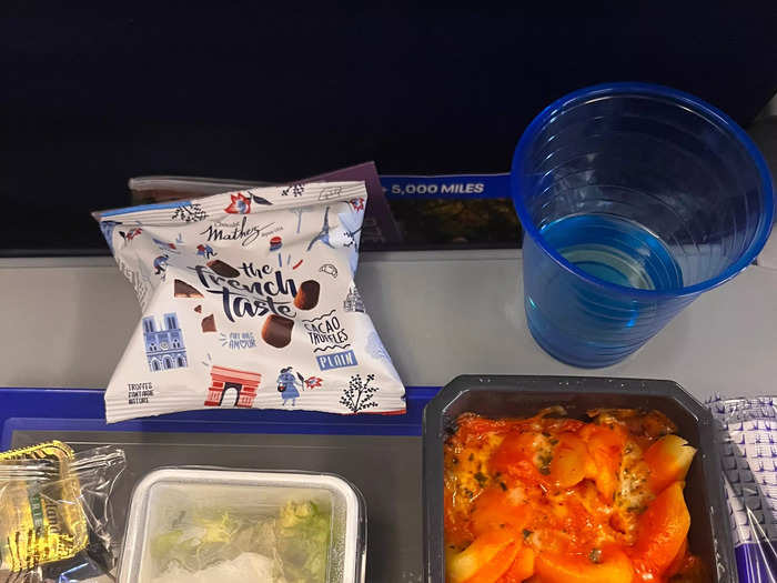 Meanwhile, in economy, everything — including my complimentary glass of wine — was served in plastic and there was no tablecloth.