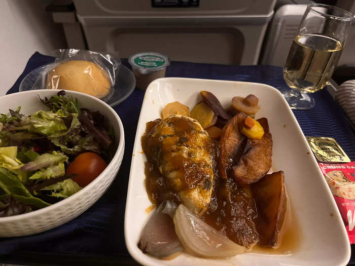 There was also a major difference in the food. In premium plus, I was served my meal on a small tablecloth and had actual silverware. My complimentary wine also came in an actual glass.