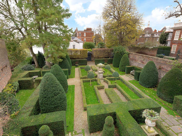 It has a 120 ft walled garden with hedges, pathways, trees and topiary and a secluded bench, per Savills.