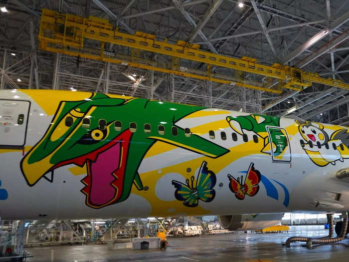 Wrapped around the fuselage is also Rayquaza, a so-called "legendary" Pokémon that resembles a green dragon.