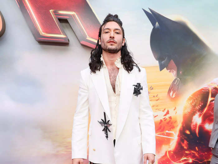 Ezra Miller posed for photos on the red carpet in a white jacket, black pants, and Doc Martens.