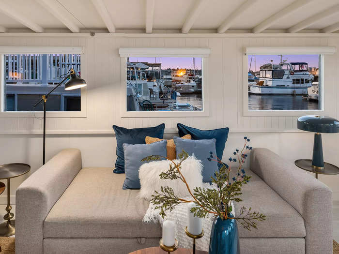 The windows that line the living-room area look out on to Lake Union and neighboring boats.