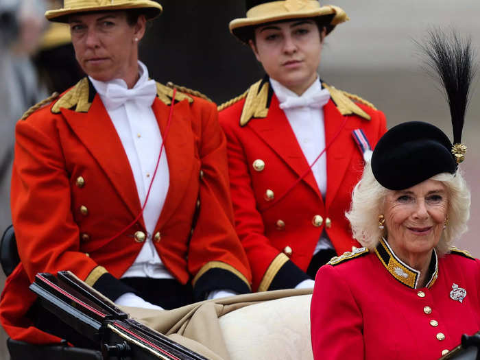 Camilla wore a red silk coatdress that paid tribute to the royal guards who were marching at the parade.