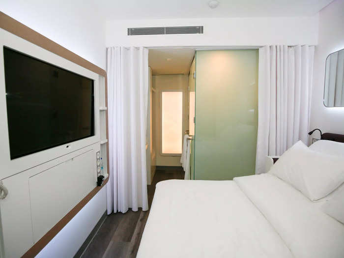 My "premium queen" room — the smallest 140-square-foot option — was bleakly modern with white walls and decor reminiscent of a Japanese capsule hotel.