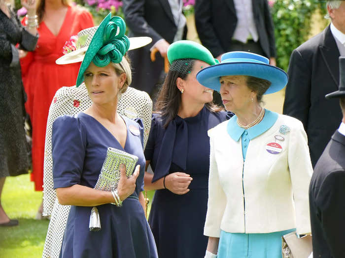 On day two, she chose a satin blue dress by Laura Green, while her mother wore a classic cream-colored jacket over a bright-blue dress with a matching hat.