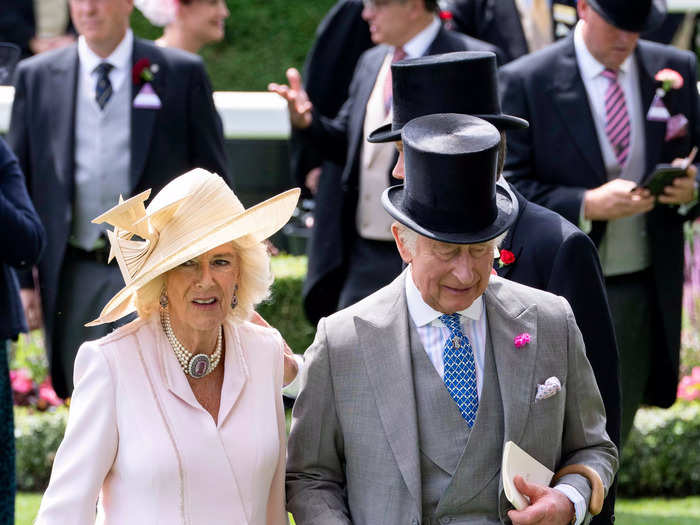 For day two, Camilla chose another coatdress — this time in pale pink — while Charles wore a blue tie with his grey suit and top hat.