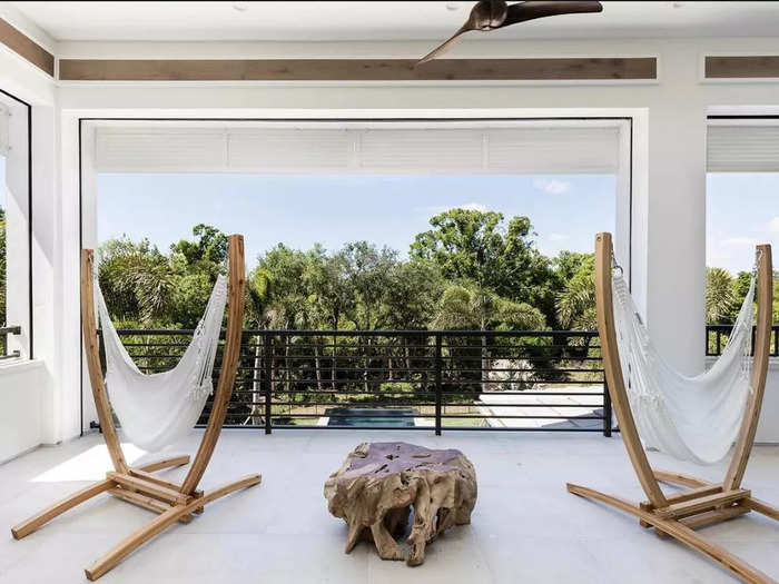 The second-floor balcony, which also overlooks the pool, has hammocks for lounging.