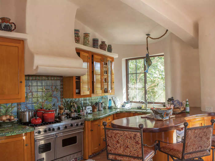 Despite the home being shell-shaped, there are traditional elements, such as the straight windows in the kitchen.