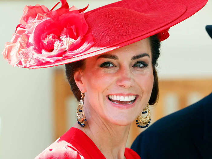 Her coordinating hat by Philip Treacy featured large flowers, keeping with her floral-hat theme.