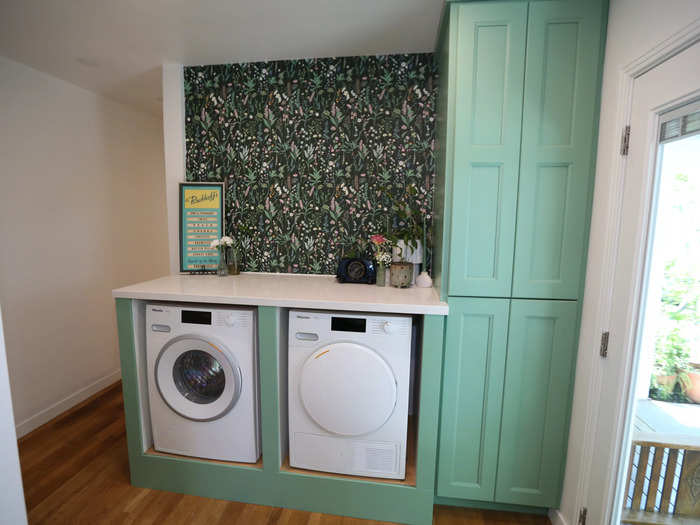 They updated the laundry room by expanding its walls and replacing its washer and dryer.