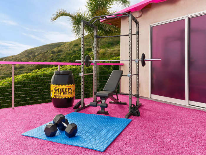 An outdoor deck has been converted into a mini fitness studio with different sets of weights. After all, it