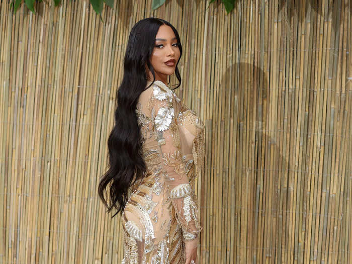 Munroe Bergdorf glittered like gold in a sheer, delicately embroidered floor-length gown.