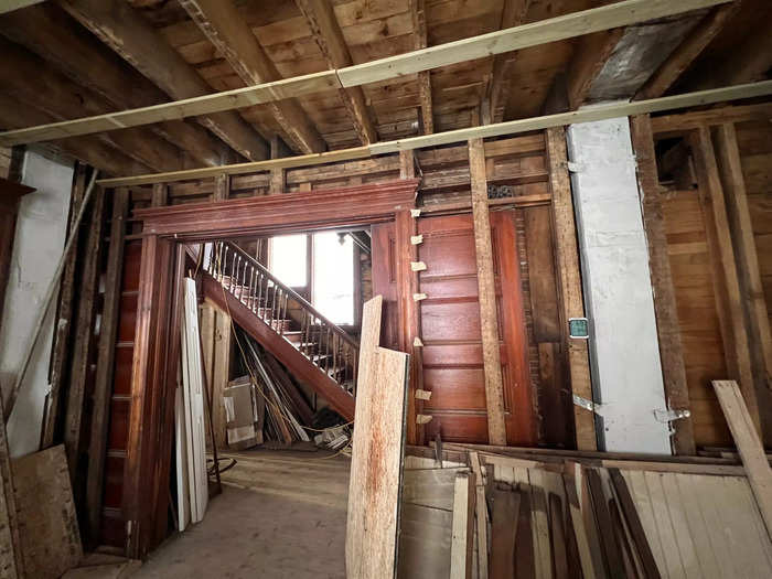 An original doorframe standing in an unfinished room.