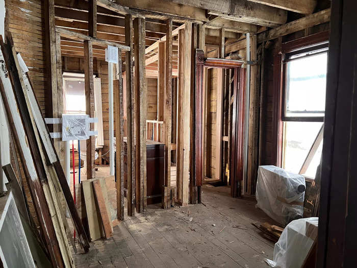 A Victorian-period doorframe standing in an unfinished room.