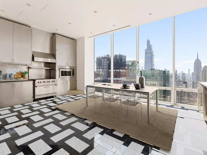 A kitchen with floor-to-ceiling windows in a penthouse.