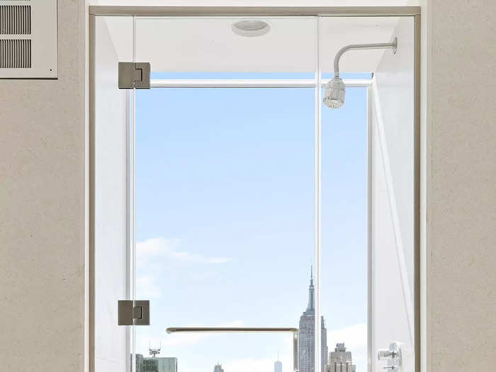 A walk-in shower with a floor-to-ceiling window.