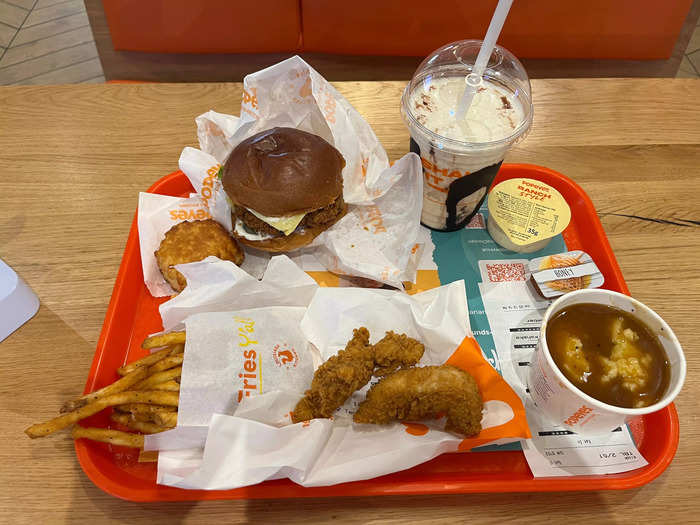 I ordered a deluxe chicken burger, a biscuit, a chocolate orange milkshake, chicken tenders, mashed potatoes with cajun gravy, and ranch sauce.