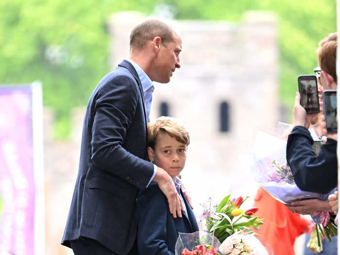 George, who will become the next Prince of Wales when William is king, stood close to his dad who rested his hands on George