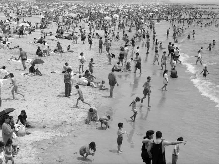 The beaches were also popular in the mid-1990s. In a photo dated 1995, children can be seen running and playing in the water while parents look on.