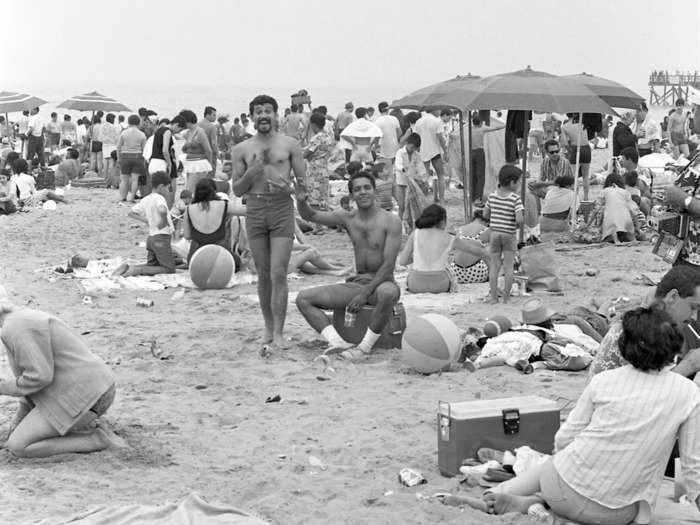 Thirty years later, revelers still visited Coney Island Beach to celebrate Independence Day. In this photo, a pair of unidentified men in shorts pose for the camera.