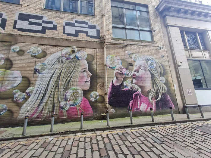 The first mural showed two young girls blowing bubbles, which had a 3D effect.