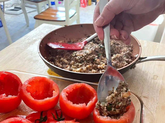 Using a spoon, fill each tomato cup with the beef and rice mixture.