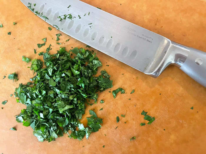 We begin by chopping the onion and parsley.