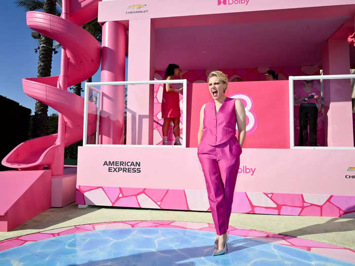 Kate McKinnon posed in front of the mini Barbie dollhouse that was built on the carpet.