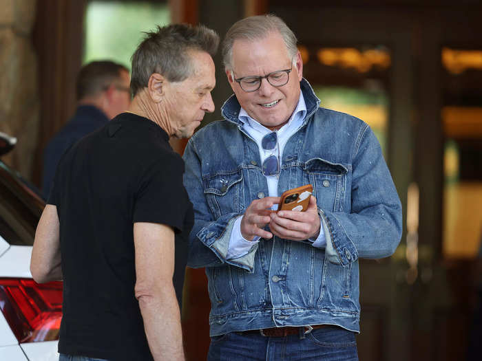 Grazer gave David Zaslav a hug and showed him something on a phone outside the lodge.