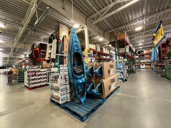 Aisles of sporting equipment featured kayaks, bicycles, and scooters.