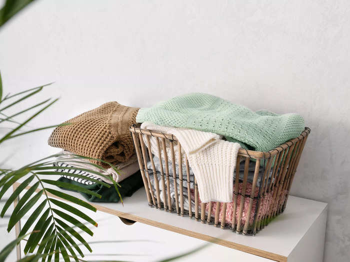 Use woven baskets, fabric bins, or vintage crates to neatly store and display items.