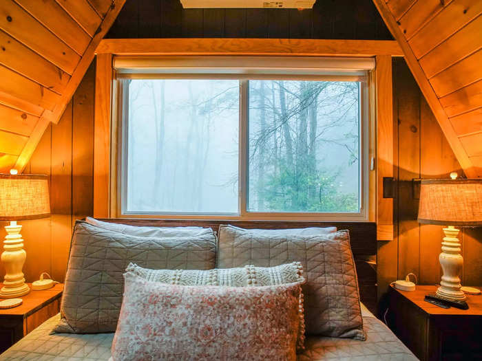 With wood paneling and vast windows, I thought the cabin made me feel immersed in nature from the comfort of a cozy bed in a heated home.