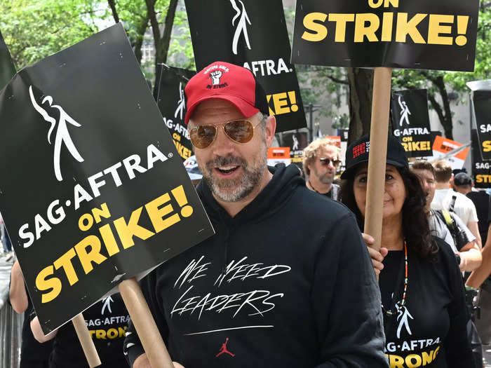 Wearing a "We Need Leaders" Jordan hoodie, "Ted Lasso" star Jason Sudeikis joined WGA and SAG-AFTRA members picketing outside of NBC Universal in New York City.