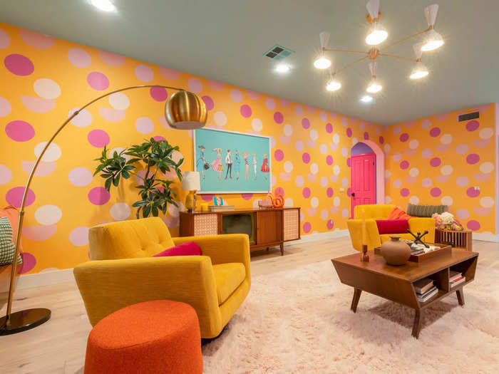 The designers made the room pop with yellow walls covered in pink and white polka dots. All of the furniture had a mid-century modern look, which was fitting for the 1960s-inspired space.