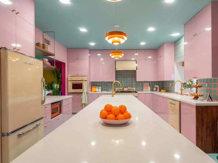 But Lofaso and Roth extended the island to offer seating. A teal-and-pink patterned tile backsplash connected the pink cabinetry and teal ceilings.