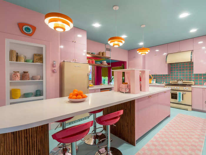 The designers bathed the kitchen in pale pink and installed retro, yellow appliances, capturing the 