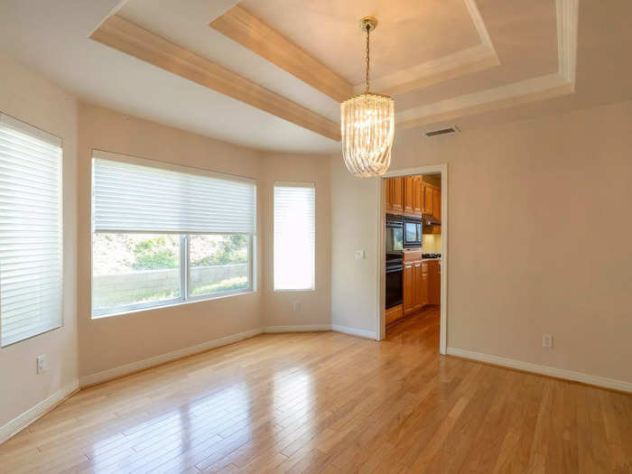 Oversized windows made the dining room feel bigger, though it was shut off from the kitchen.