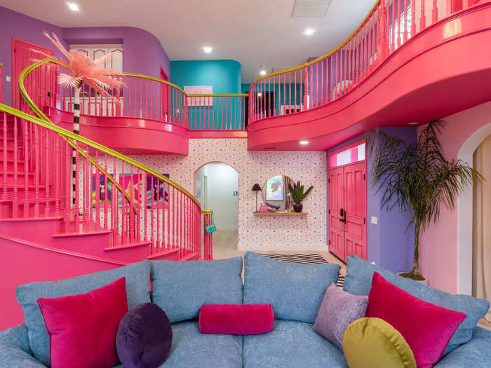 Sherrod and Jackson painted the stairs hot pink with yellow banisters, making them a focal point. They also used purple and blue paint upstairs for a playful look.