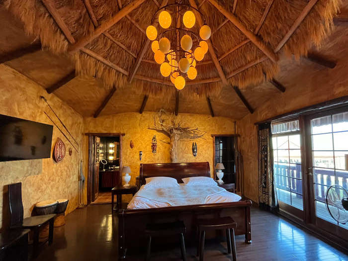 The thatched-hut ceiling, made with wheat from a local farm, was decorated with a glowing chandelier.